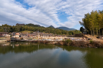 Fototapeta na wymiar Beautiful mountain village, with lake, blue sky, house and grassland