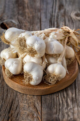 fresh ripe garlic on wood background. Close up