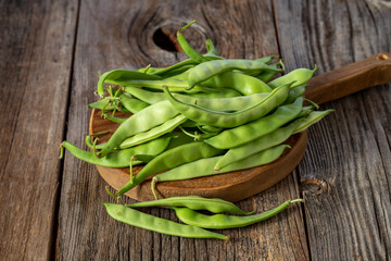 fresh ripe green beans on wood background