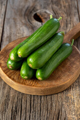 fresh ripe cucumbers on wood background. Close up