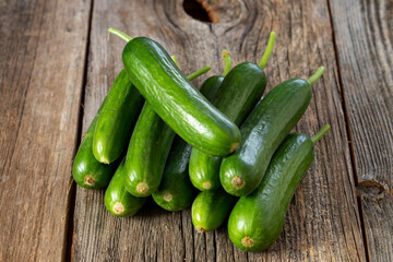 fresh ripe cucumbers on wood background. Close up