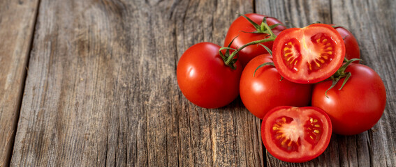 fresh ripe bunch tomatoes on wood background. Copy space