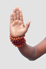 a persist showing his hand with rudraksha beads,for blessing.