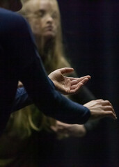 Obraz na płótnie Canvas dancer hand silhouette on blured bg dance performance improvisation expressive authentic movement