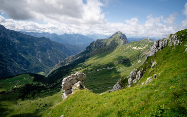 The high Plateau of Montasio with green pastures in summer and Julian Alps (Jof di Montasio). Udine, Friuli Venezia Giulia, Italy, Europe