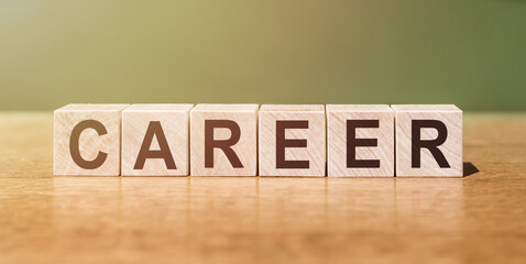 CAREER word written on wooden blocks on wooden table. Concept for your design.