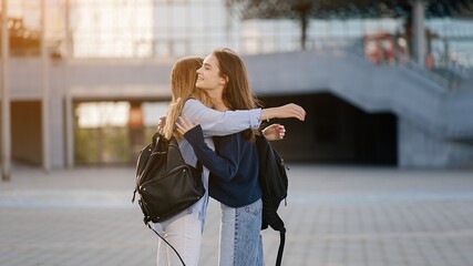 Two teenage girls met at school or college after vacation