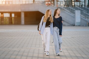 Two teenage student friends girls happy going to college or school