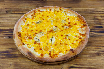 Pizza Four cheese on a wooden background