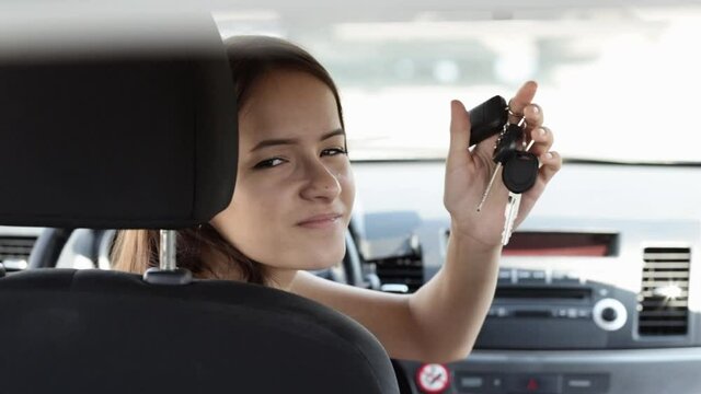 teenager in car, buying a car, a happy woman driving with car keys
