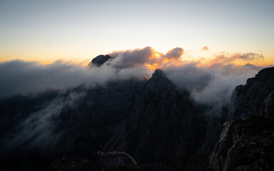 Mist and clouds in rocky mountains. Beautiful dramatic scenery in nature.