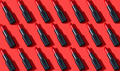 Creative pattern fashion photo of cosmetics beauty products red lipstick on a red background