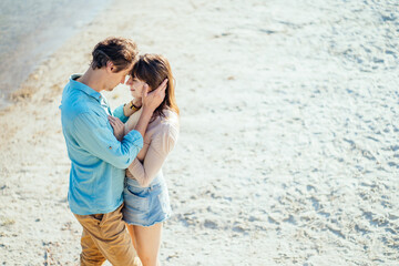 European couple on lake shore beach. Top view