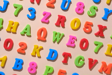 Alphabet letters and numbers as a concept for back to cheekbones. Minimal pastel education idea.