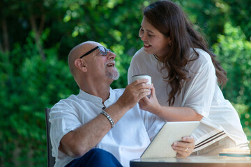 Caring wife giving cup of coffee for her husband, lovely couple, comfort moment with his wife