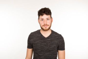 Obraz premium Serious dark-haired Caucasian young man with beard looking at camera