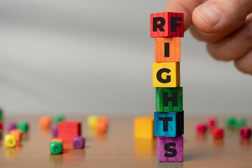 Wooden cubes make up the words rights and fights