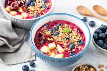 Superfood smoothie bowl with granola and berry topping. Low calorie vegan detox meal