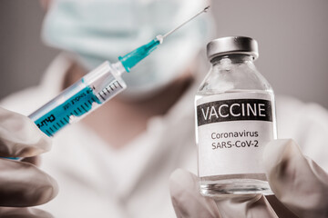 A little single glass bottle vial of new Covid-19 vaccine. Healthcare concept vaccination injection treatment.