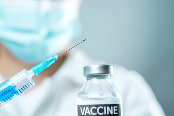 A little single glass bottle vial of new Covid-19 vaccine. Healthcare concept vaccination injection...