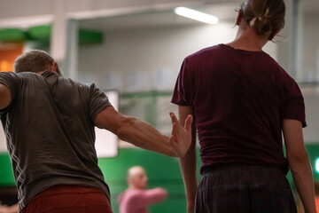 two dancers contact hands in contact improvisation on the bg a CI jam intentionally with motion...