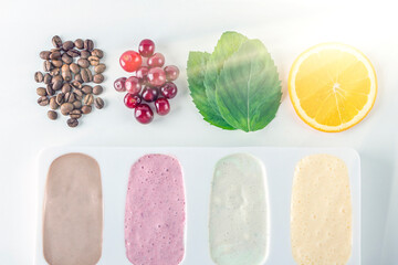 Homemade cooking vegan diversity  popsicles from cherry, mint, orange, coffee and coconut milk. Natural fruit and berry pink ice cream sugar free