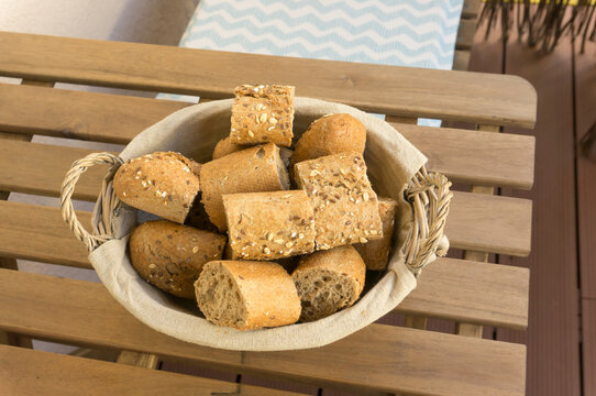 Pieces Of Bread In A Bowl On A Wooden Table Viewed From Above