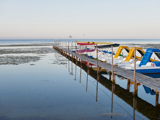 Obraz premium Morning at sea. Many catamarans are moored at the pier.