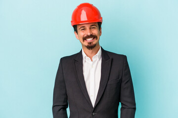 Young architect caucasian man isolated on blue background happy, smiling and cheerful.