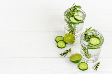 Fresh cold drink with cucumber lime and herbs in glasses © 279photo