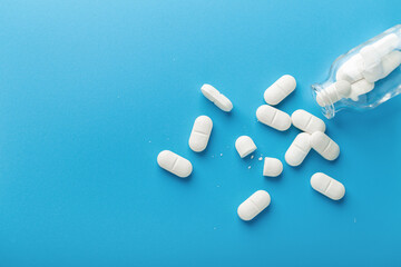 White Pills On Blue Background