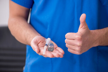 Young male doctor in vaccination concept during pandemic