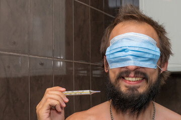 The man put a mask on his face while covering his eyes and took a mercury thermometer in his hand...