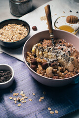 Bowl of oatmeal porridge with banana and nuts. Top view. Healthy vegan breakfast