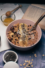 Bowl of oatmeal porridge with banana and nuts. Top view. Healthy vegan breakfast
