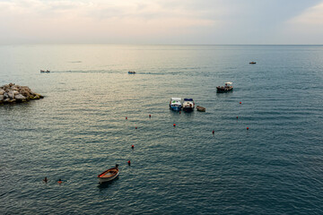 boats near the rocky shoreline at Manarola, Cinque Terre, Italy
