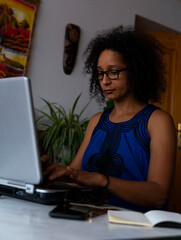 South American woman working on computer from home