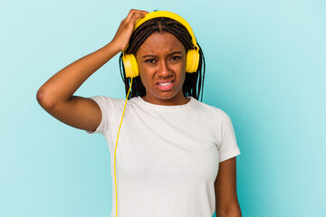 Young African American woman listening to music isolated on blue background  being shocked, she has remembered important meeting.