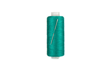 Spool of green thread and a threaded needle.