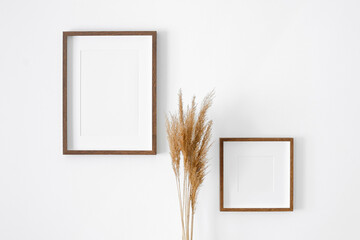 Frames mockup on white wall for photo or print presentation. Minimalistics style indoor interior...