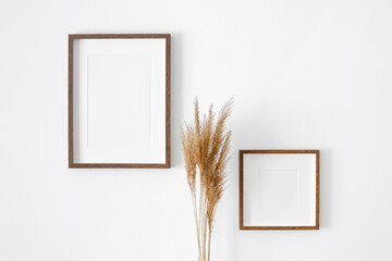 Frames mockup on white wall for photo or print presentation. Minimalistics style indoor interior...