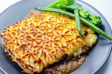 Tender minced lamb with garden veg in a hearty gravy beneath butter mash, typical Shepherd's pie