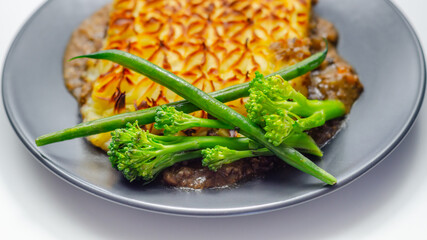 Tender minced lamb with garden veg in a hearty gravy beneath butter mash, typical Shepherd's pie