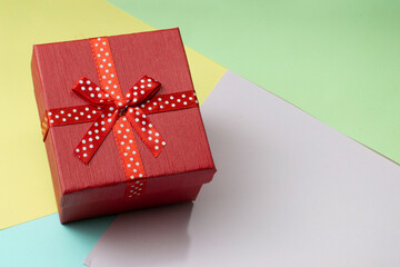 Red gift box placed on a bright colored background