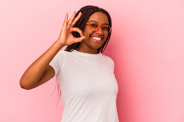 Young african american woman isolated on pink background  cheerful and confident showing ok gesture.