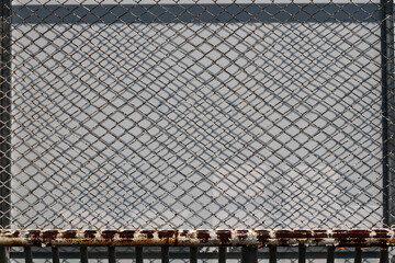 The iron fence rusts because it has been outdoors for a long time.