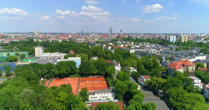 Aerial Forward Beautiful Shot Of Structures In City Against Sky On Sunny Day - Leipzig, Germany