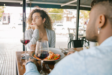 Woman getting bored at a date at a restaurant.
