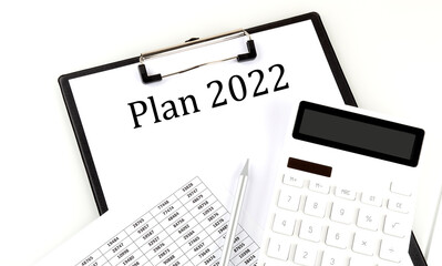 PLAN 2022 text on folder with chart and calculator on white background
