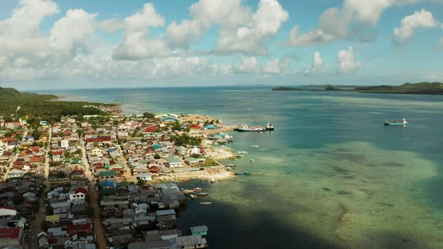 Ferry terminal with ferry and ships in the town of Dapa, Siargao island, from above. Summer and travel vacation concept